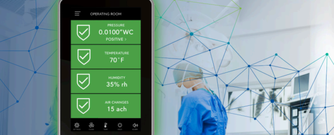 Triatek room controller touchscreen showing operating room pressure, temperature, humidity, and air change readings