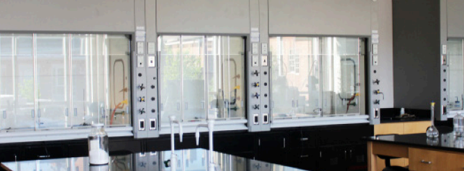 Laboratory fume hoods with monitoring controls in a bright university research lab