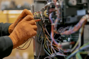 Male electrician hands repairing coffee machine in workshop Male electrician hands repairing coffee machine in workshop